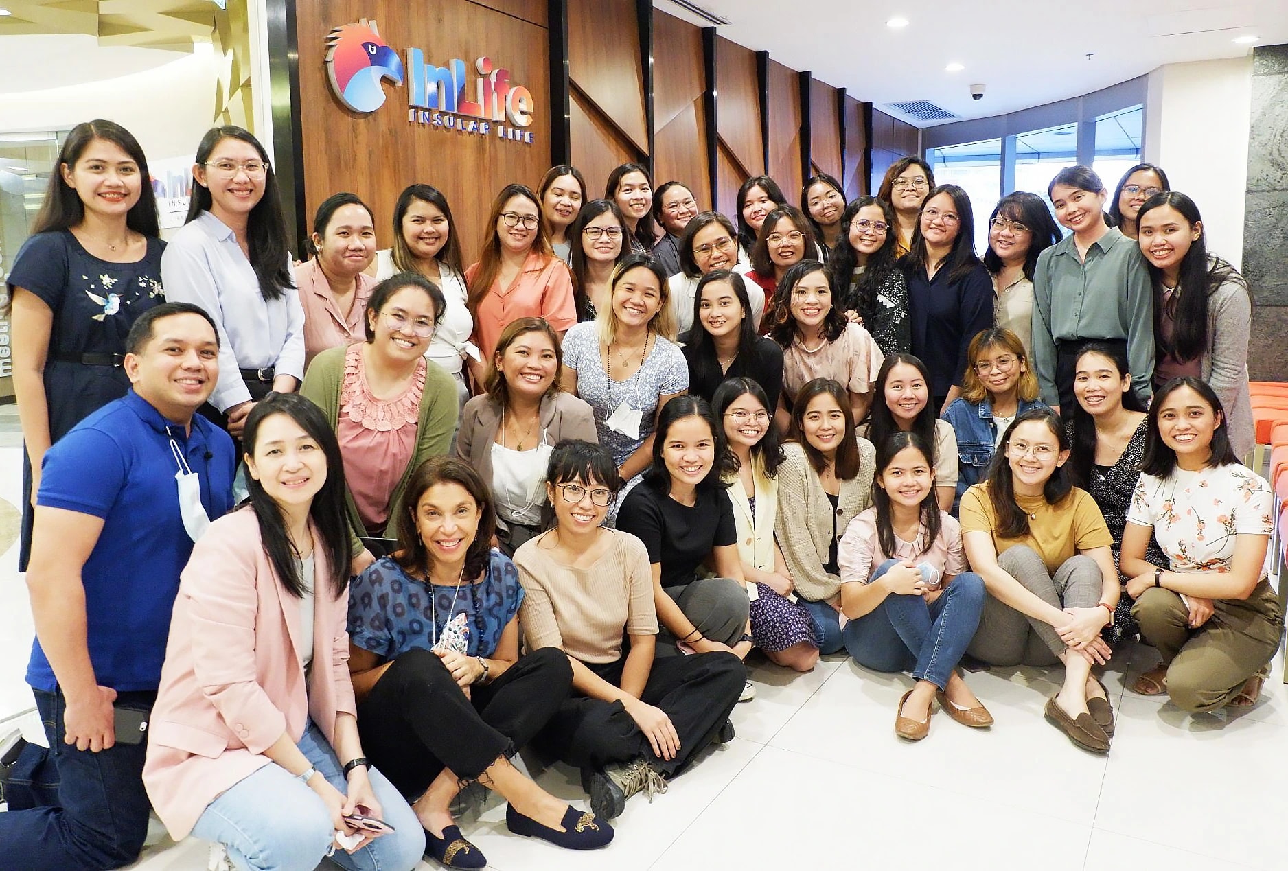 Michelle Alarcon posing with For The Women Foundation graduates and the foundation’s operations and learning team.